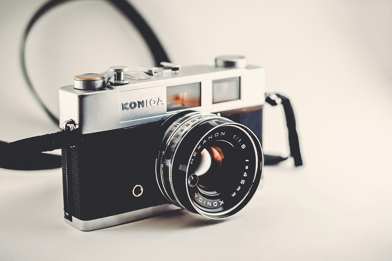 a close up of a camera on a table, a picture, by Konrad Witz, on a pale background, with instagram filters, konica minolta, professional profile picture