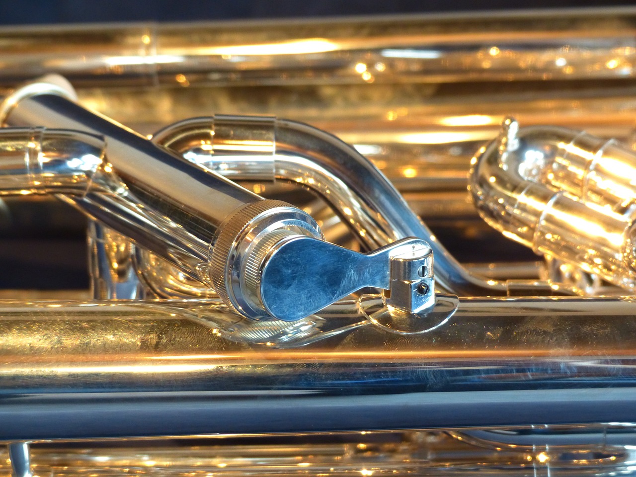 a close up of a silver and gold trumpet, pixabay, precisionism, bass drum, glass and gold pipes, [ [ hyperrealistic ] ], pitch bending