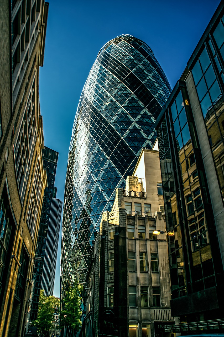 a very tall building sitting in the middle of a city, by Jay Hambidge, pixabay, modernism, geodesic building, the fabulous city of london, buildings carved out of stone, with shiny glass buildings