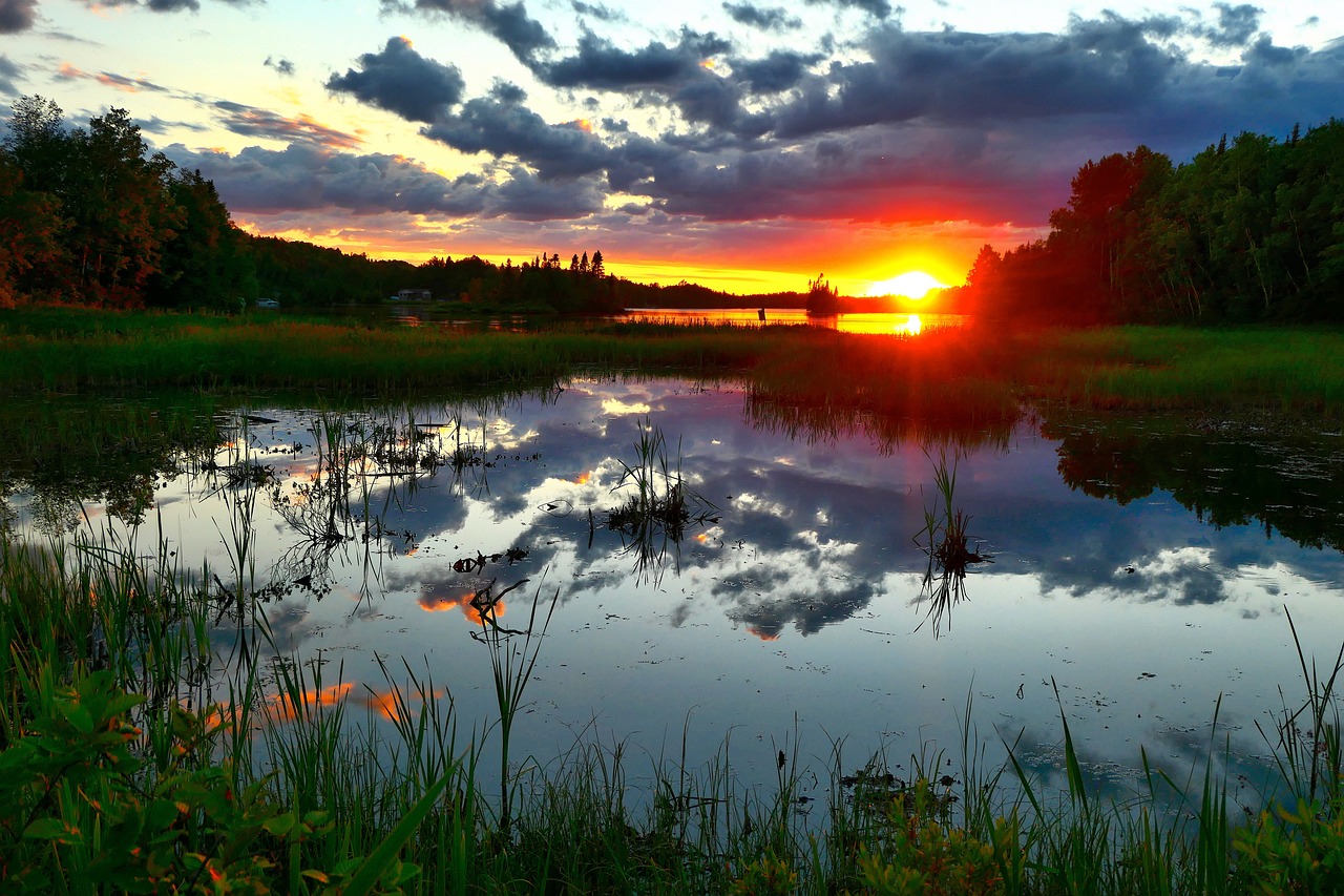 the sun is setting over a body of water, a picture, by Anato Finnstark, pixabay, the brilliant dawn on the meadow, fire reflection, sweden, after rain