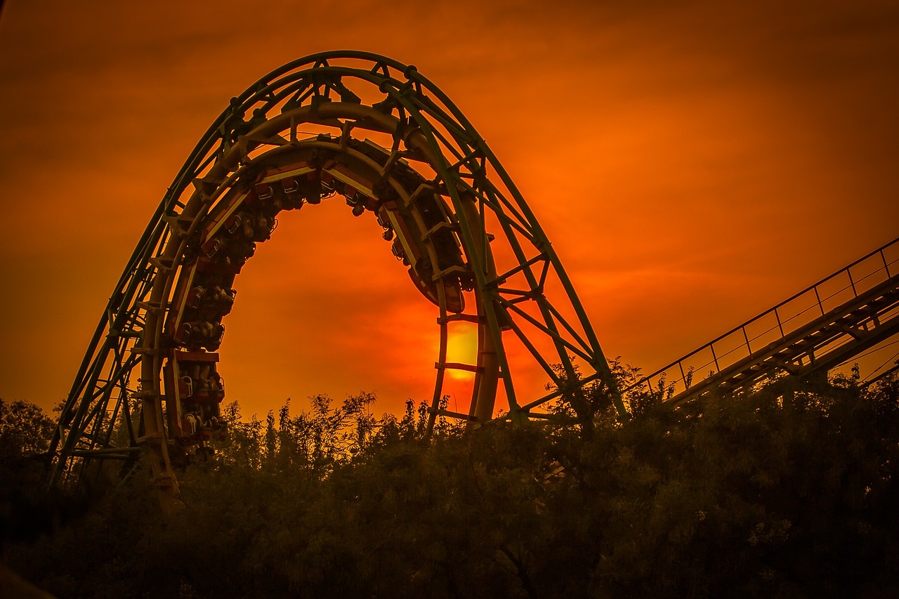 a roller coaster in an amusement park at sunset, a picture, by Mathias Kollros, pixabay contest winner, romanticism, portal to hell, dappled golden sunset, vine twist, t - rex