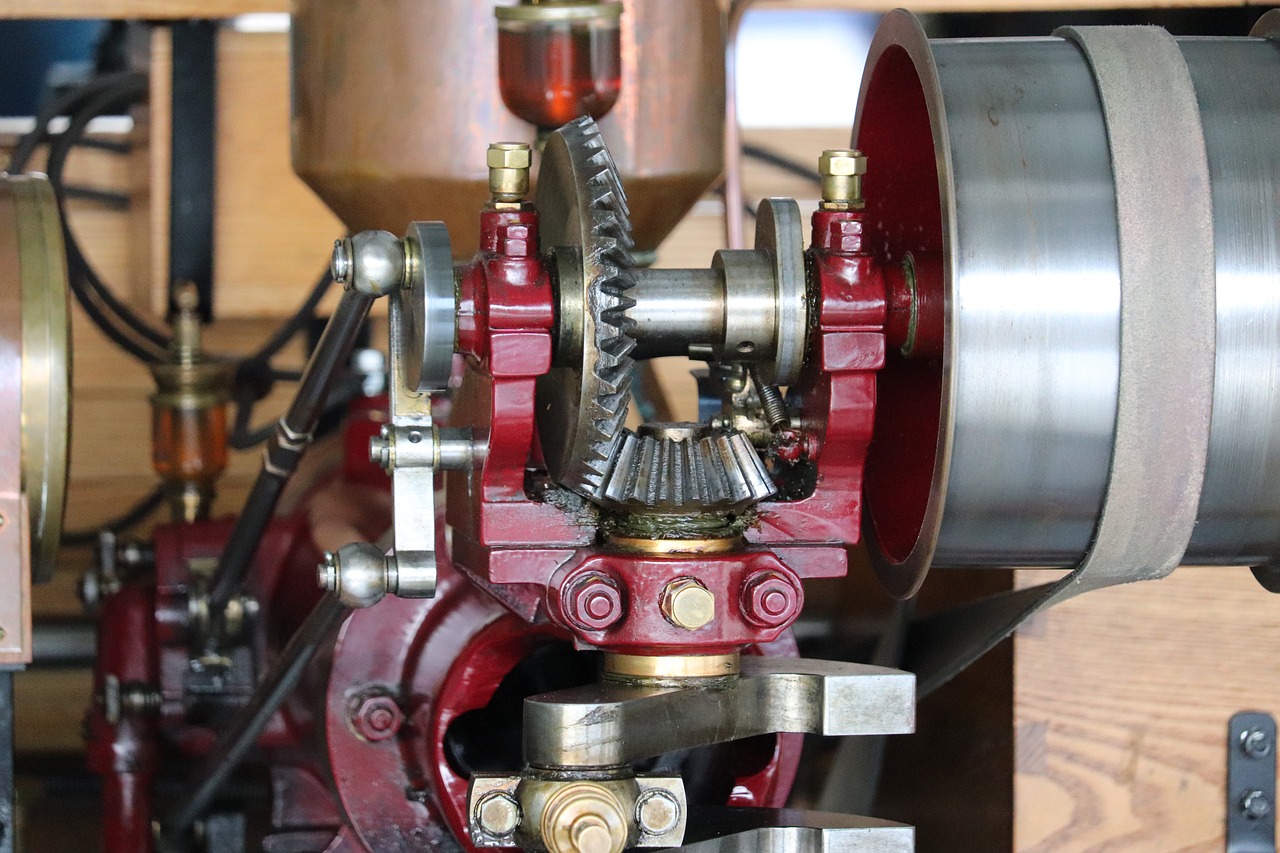 a close up of a machine on a table, by David Simpson, flickr, brass and steam technology, red mechanical body, woodlathe, close up front view