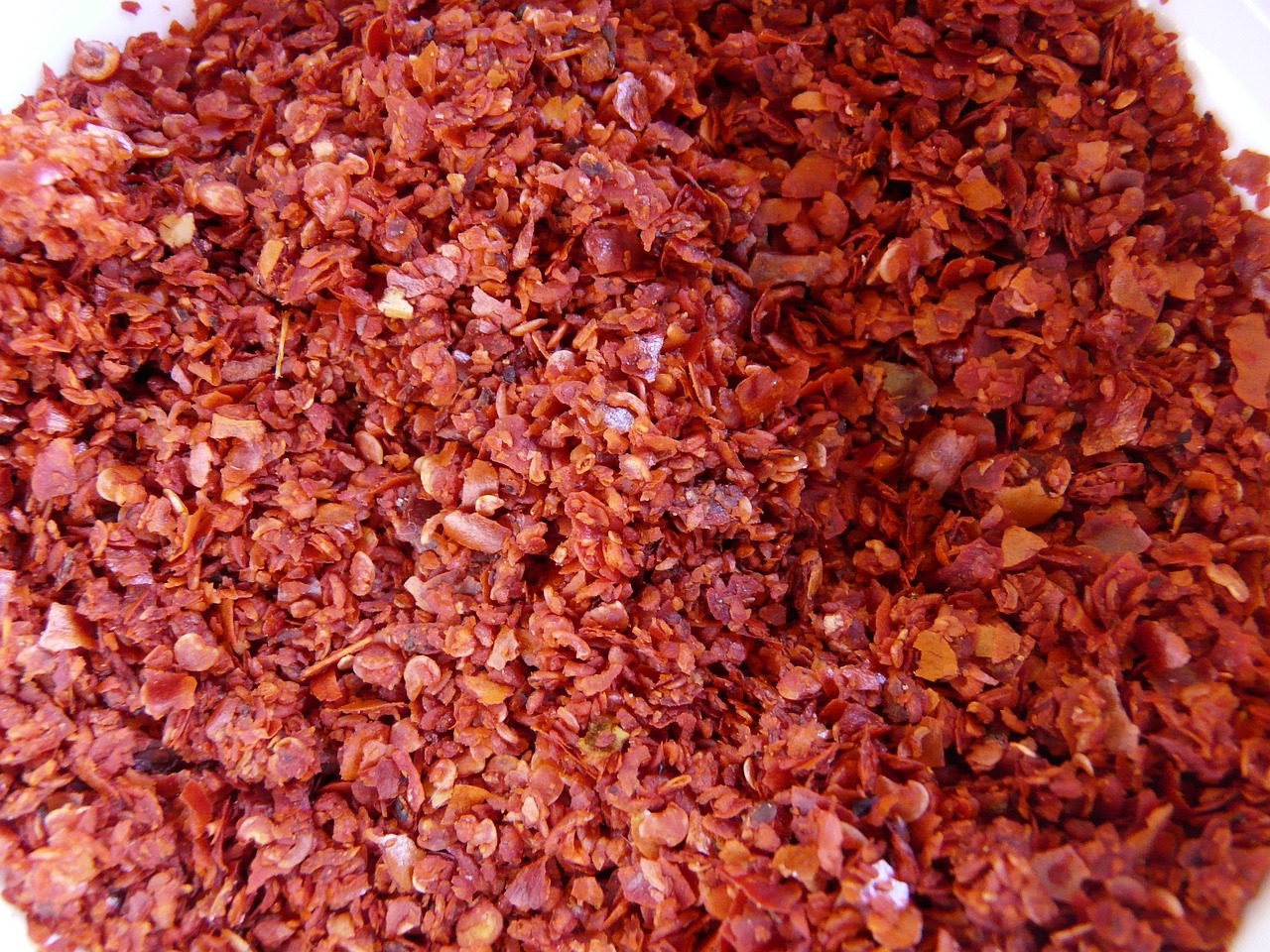 a close up of a bowl of chili flakes, by Jon Coffelt, flickr, hurufiyya, red iron oxide, detiled, hyacinth, [ closeup ]!!