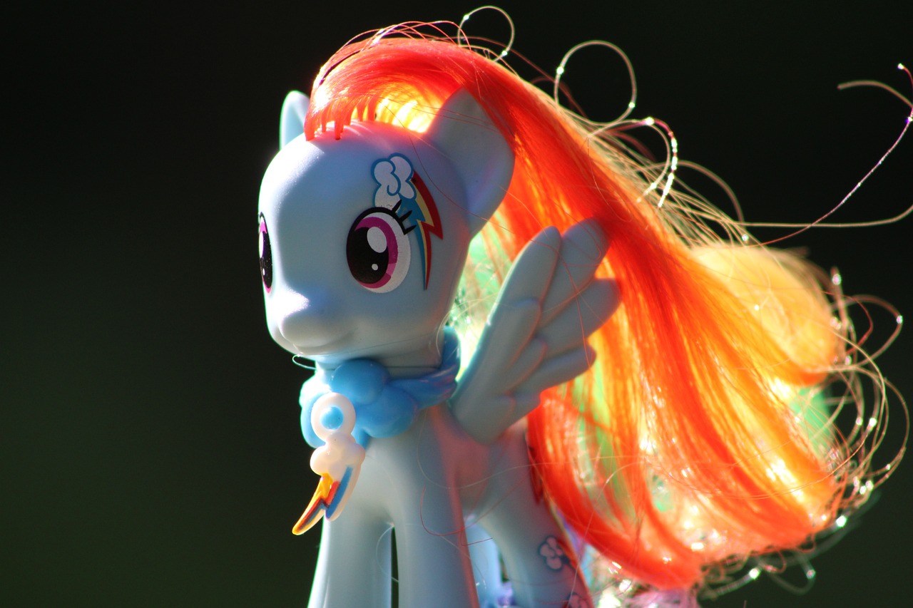 a close up of a toy of a pony, by Tom Carapic, flickr, hurufiyya, long glowing colourful hair, spitfire, flowing backlit hair, happy meal toy