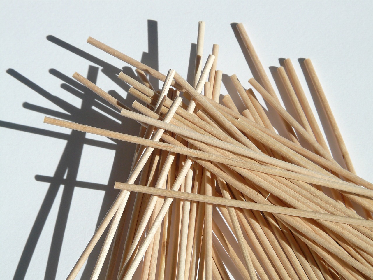 a pile of wooden sticks sitting on top of a table, trending on pixabay, conceptual art, spaghetti, japanese wood cut, rod rays, blonde