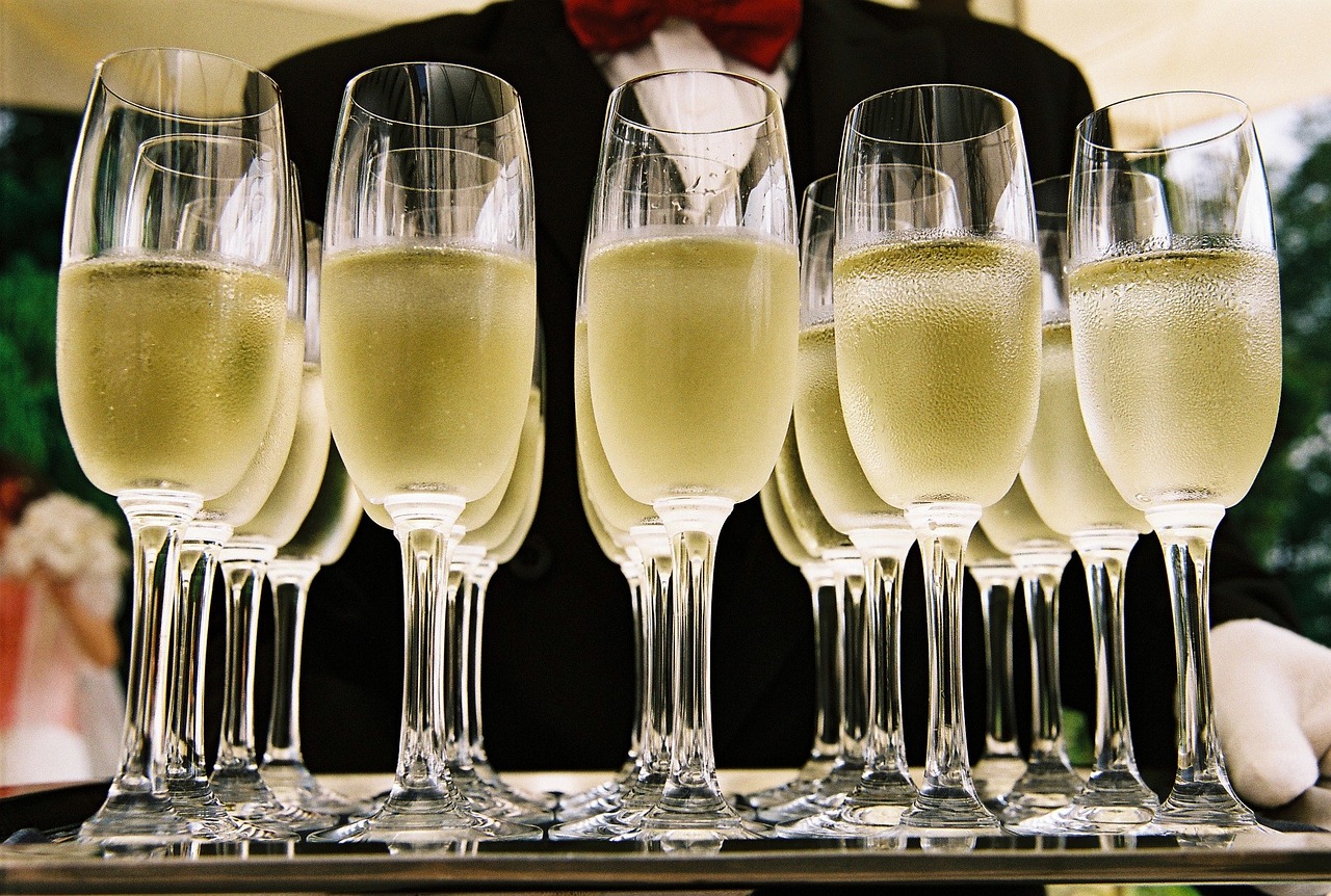 a waiter holding a tray full of champagne flutes, by John Murdoch, pixabay, ffffound, specimens in glasses, in a row, bubbles ”