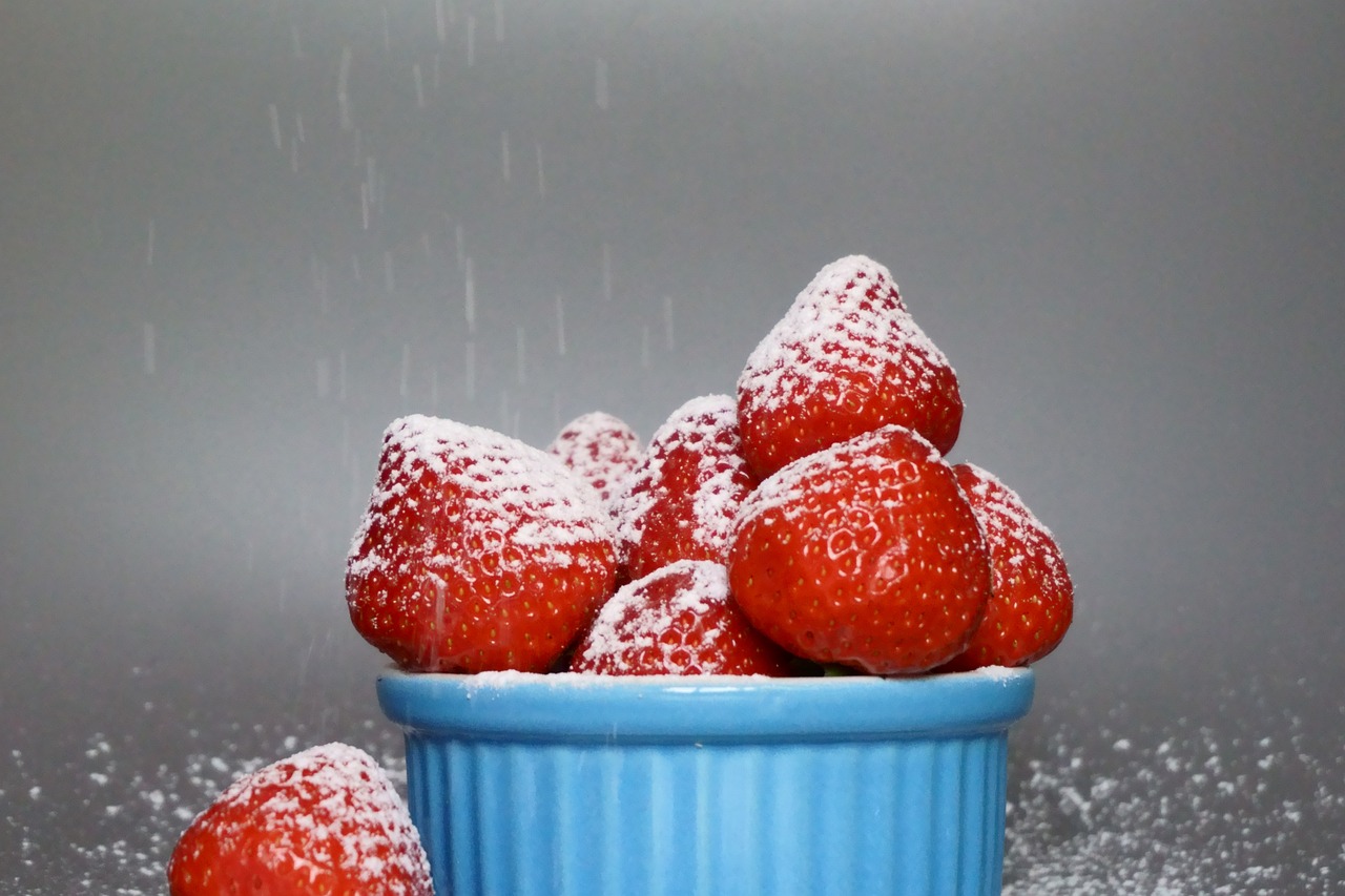 a bowl of strawberries sitting on a counter in the snow