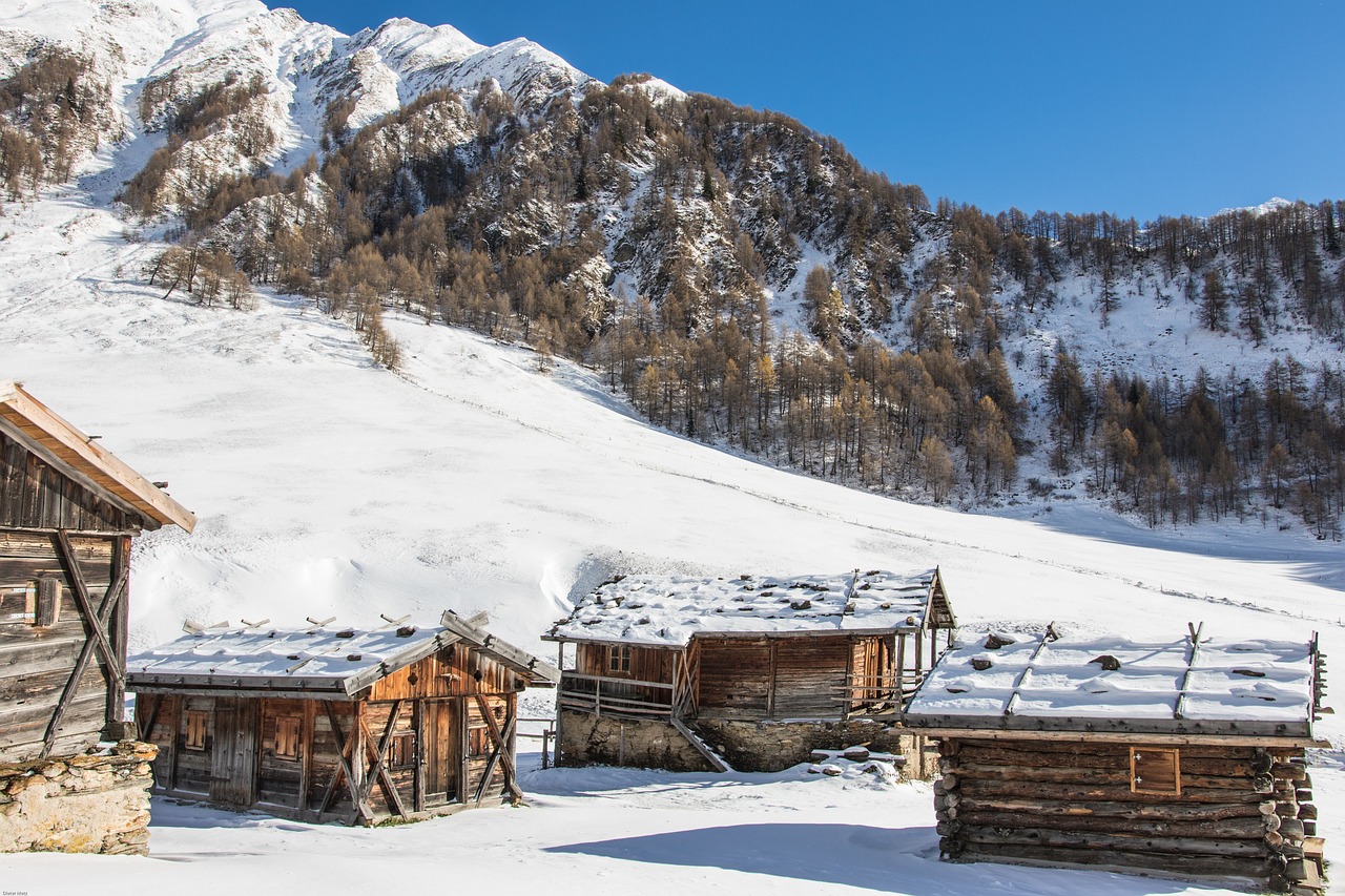 a group of wooden buildings sitting on top of a snow covered slope, a portrait, by Werner Andermatt, trending on pixabay, renaissance, italian, makeshift houses, southern slav features, interior of a mountain hut