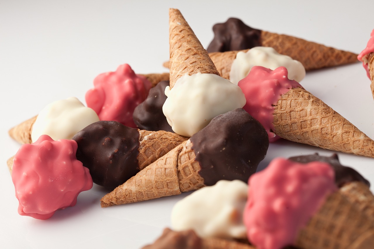 some ice cream cones with chocolate toppings on them