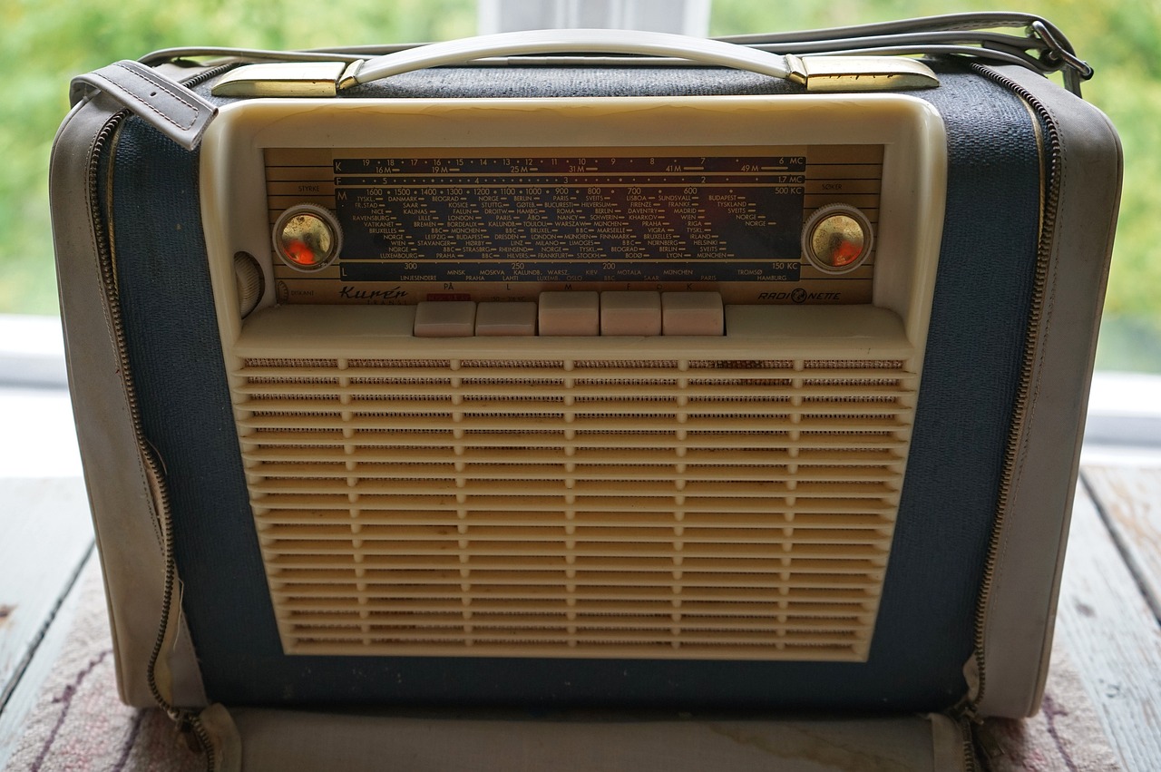 an old radio sits on a wooden table
