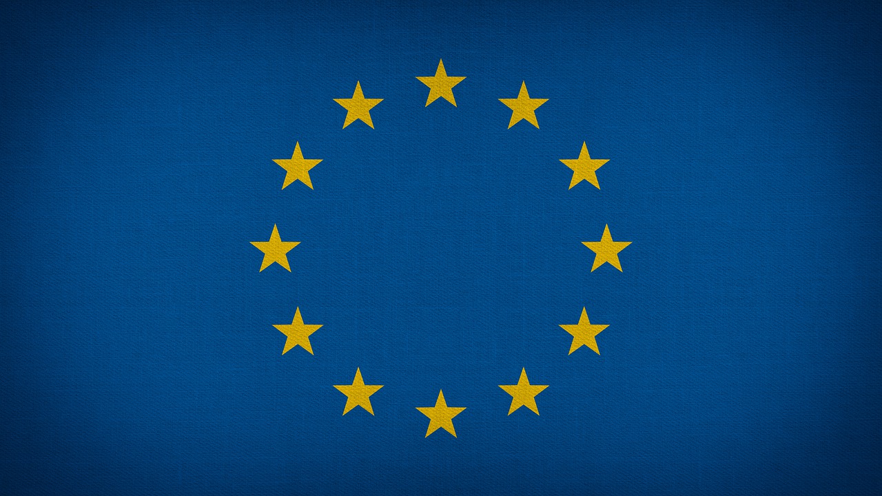 a flag with gold stars is shown on a dark background