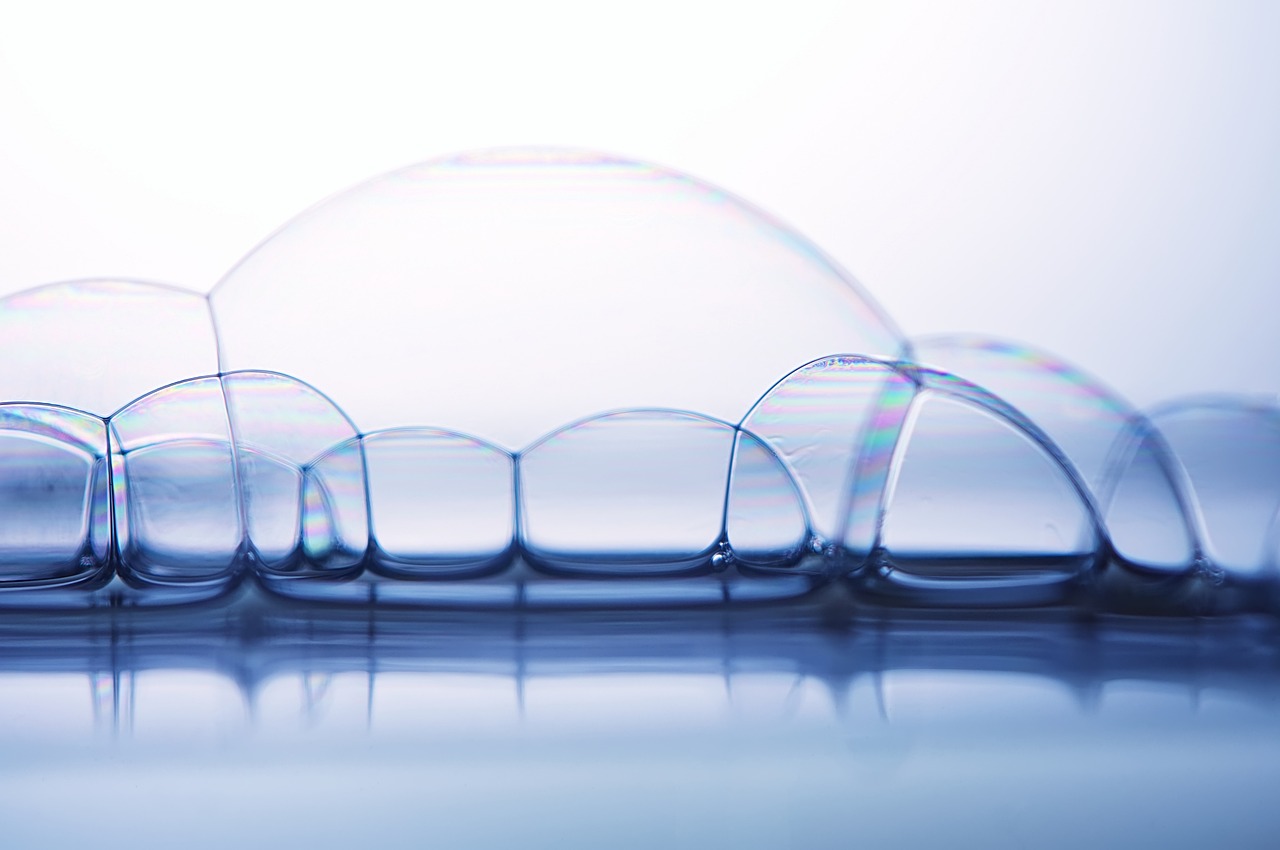 a long row of clear glass vases sitting on top of a table