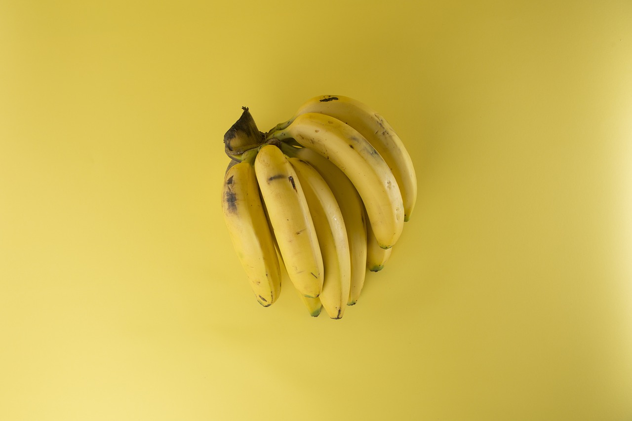 a bunch of bananas on a yellow surface