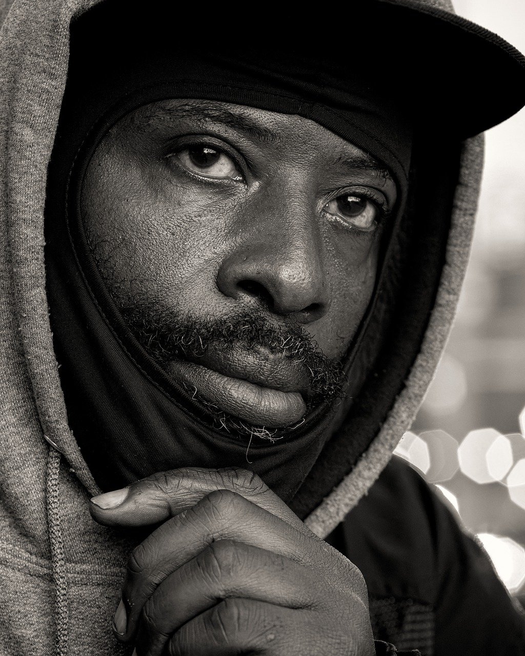 a man wearing a jacket and hat posing for a po