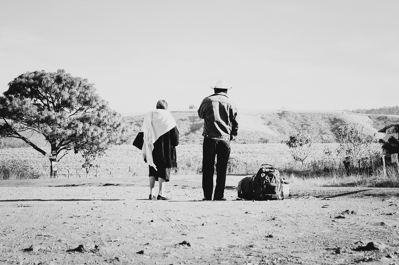 two people are standing next to each other in the desert