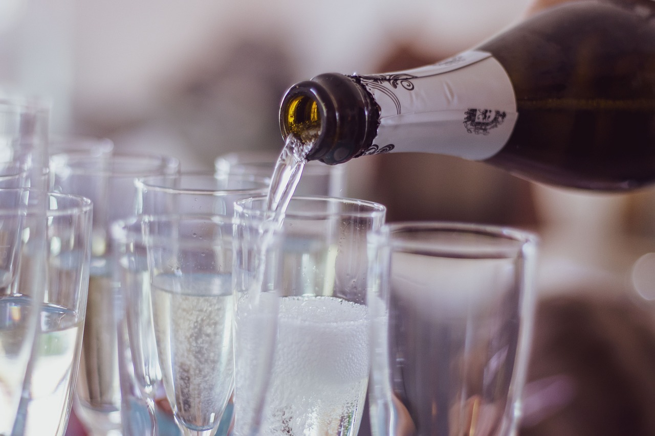 champagne being poured into champagne glasses, at a function