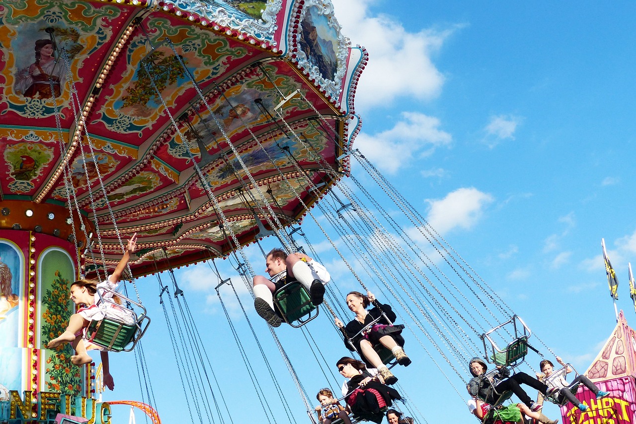 some people riding the swings of a carnival ride