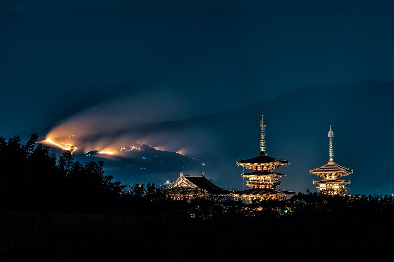 three tall towers with light at night time