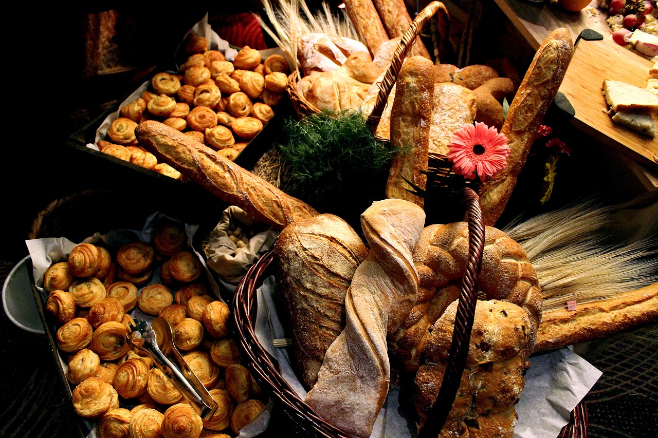 a large assortment of food including bread, rolls and mushrooms