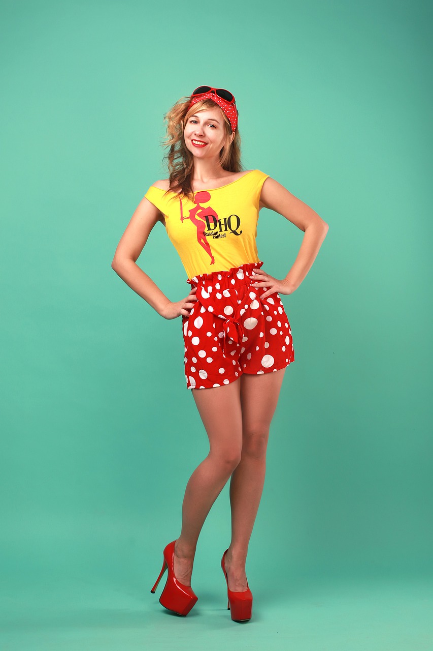a woman in shorts and top wearing red shoes