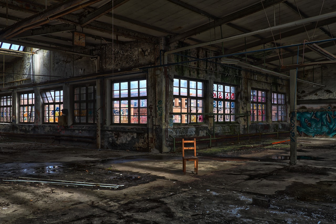 a large warehouse with windows that have bars of wood inside