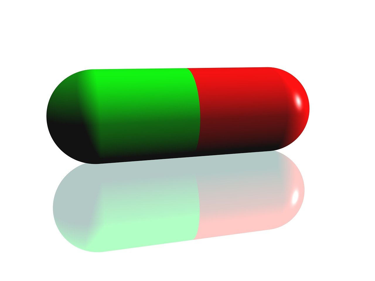 the red and green pill is on top of a white surface