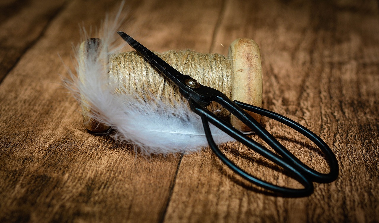 a pair of scissors sits on top of a wooden table