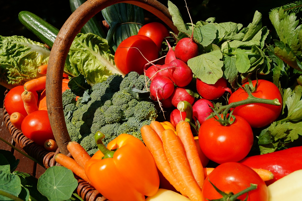 a basket filled with fresh vegetables on top of a table