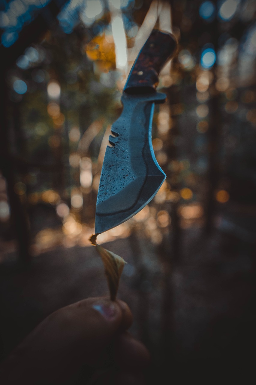 a hand holding up a blue piece of material to fly
