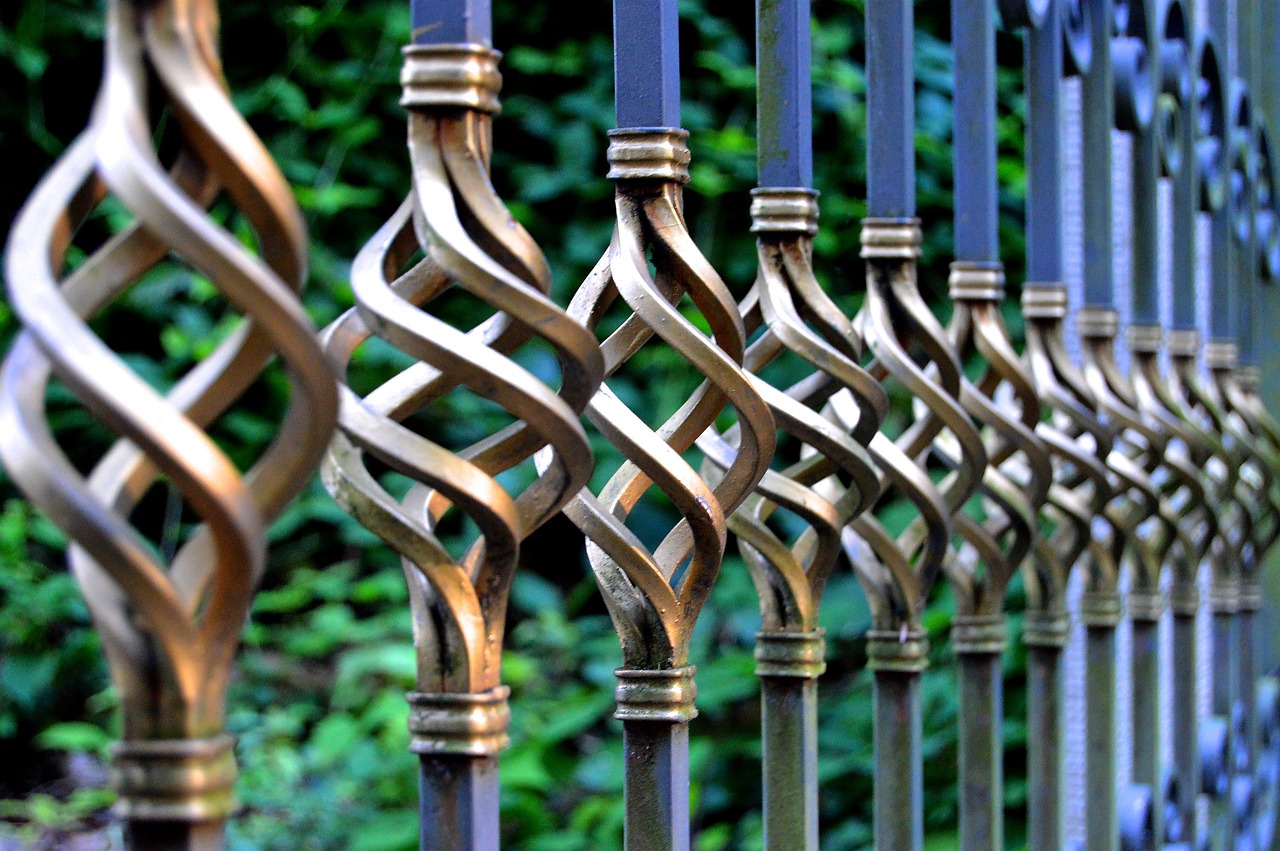 a series of metal posts with decorative designs on them