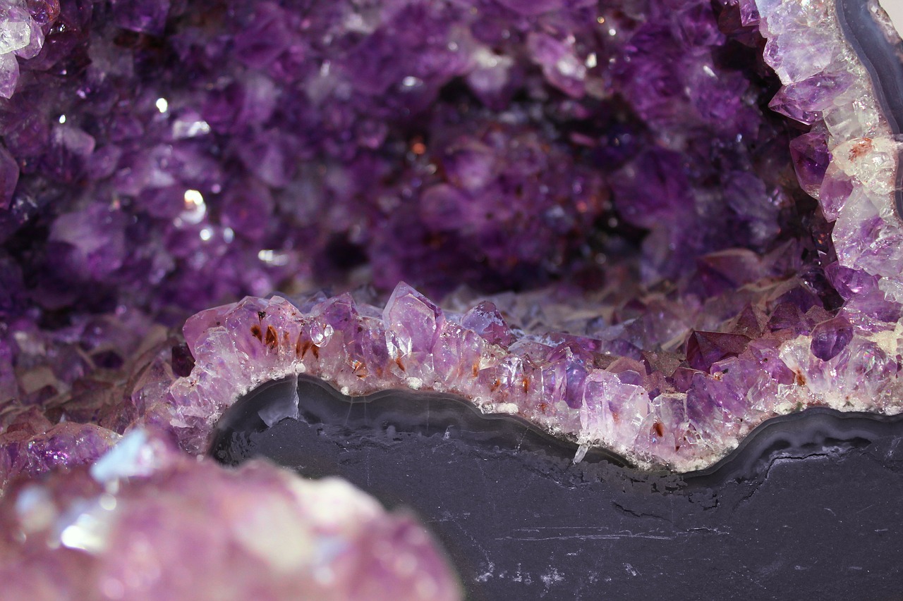 a pile of purple crystals in an old fashioned container