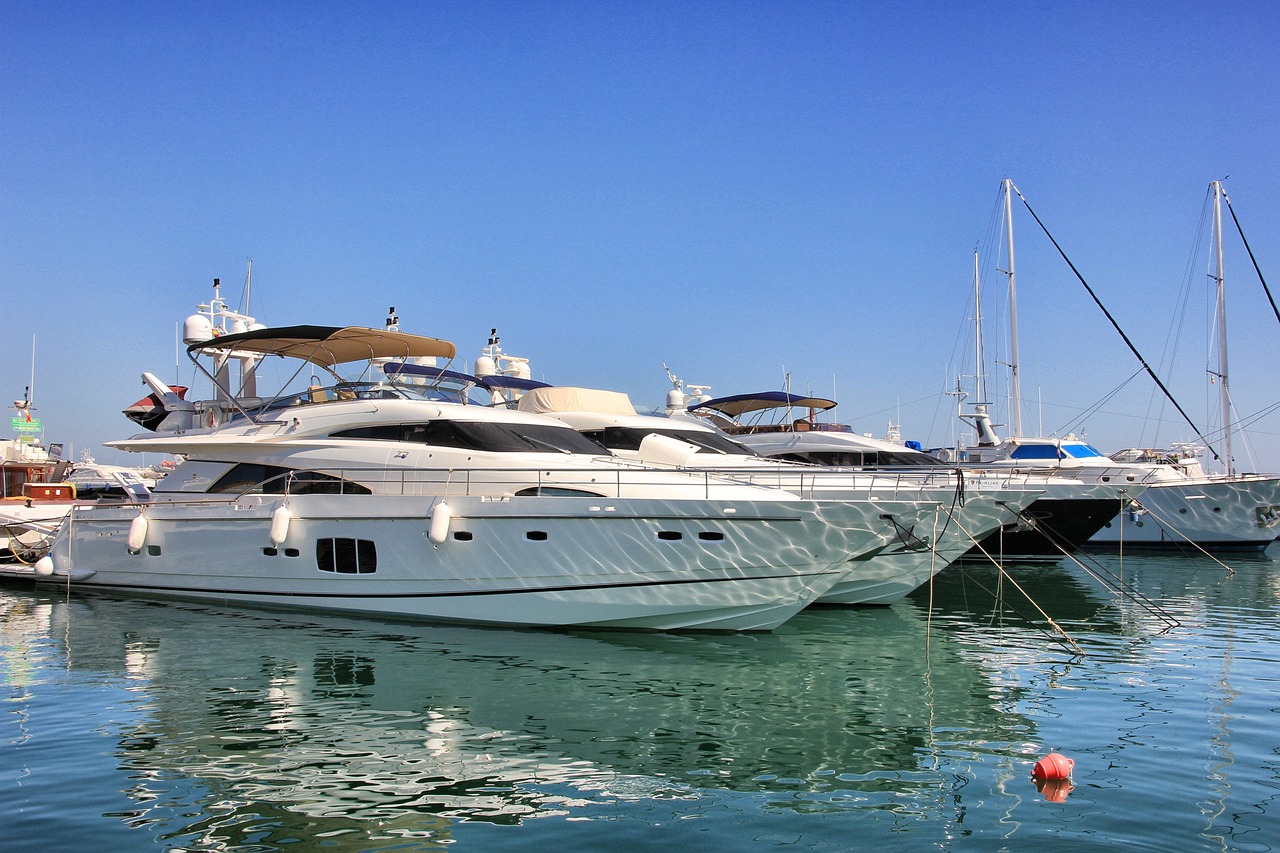 many white boats docked in the water near one another