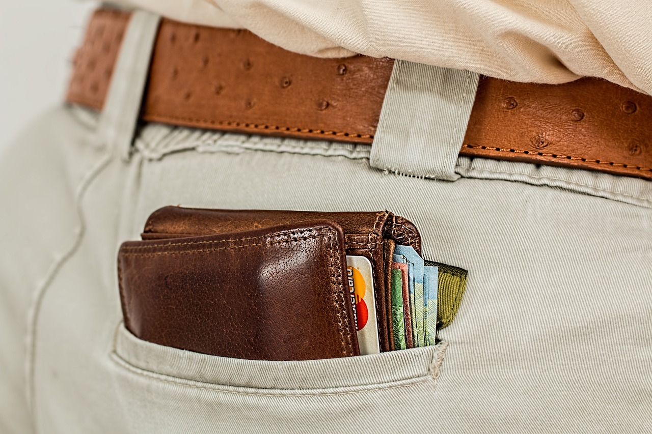 a man's wallet is in the pocket of his pants