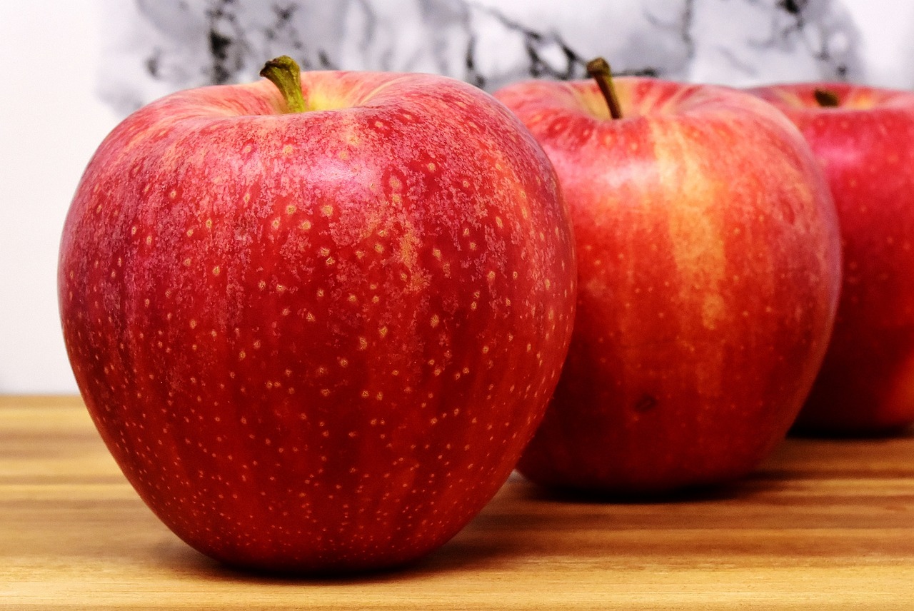 three red apples with speckles on their top