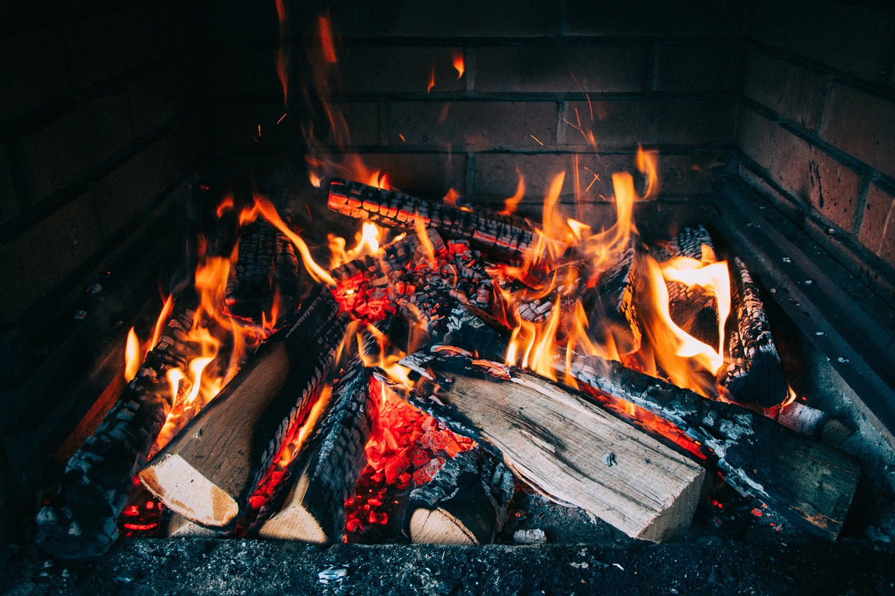 a fire burning in a fireplace with lots of burning logs