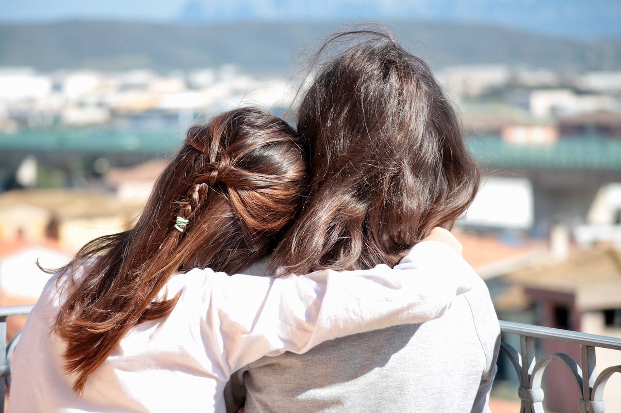 a couple of women that are looking at a city