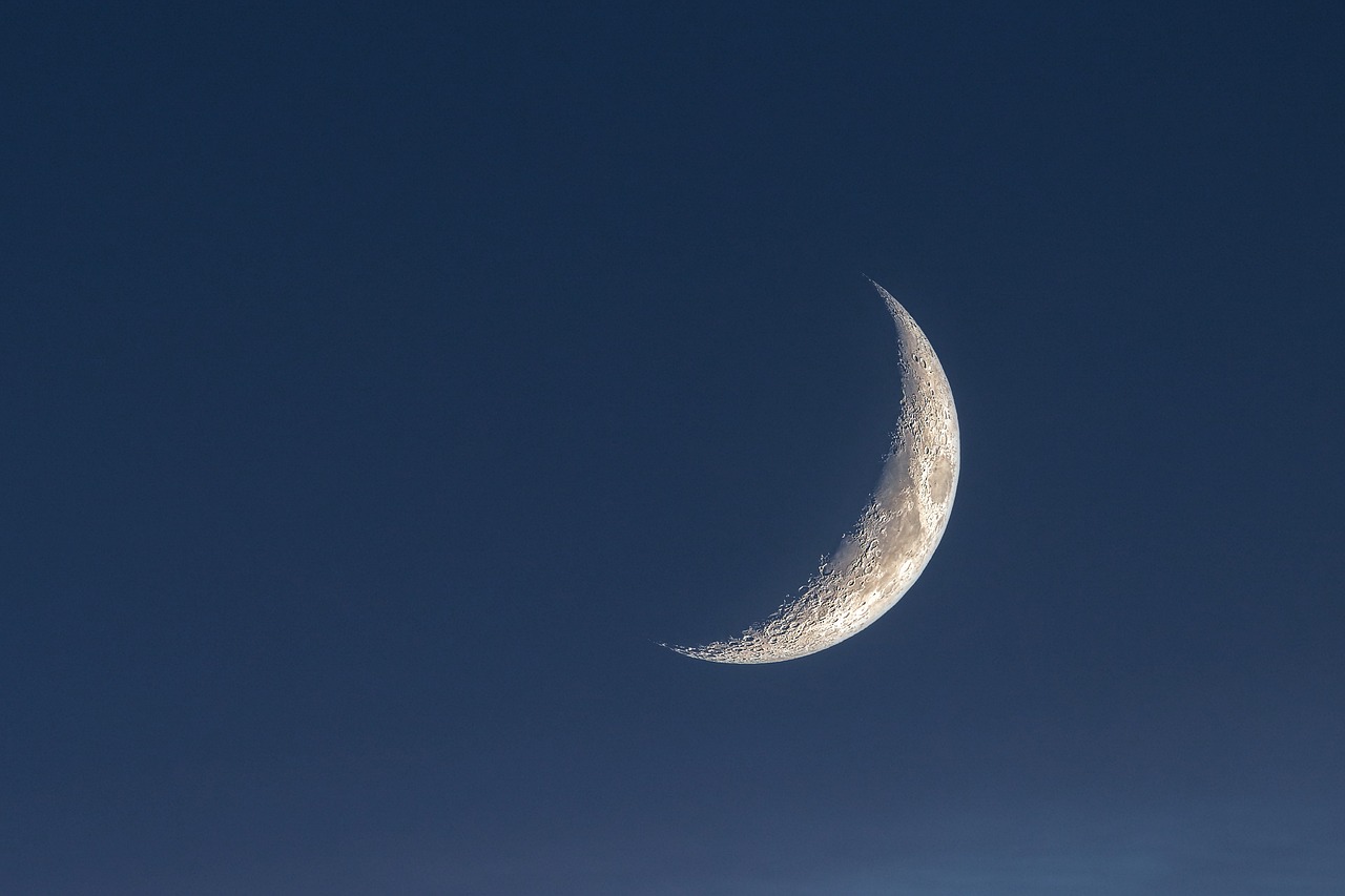 the moon is in the blue sky, and there is no image on this page