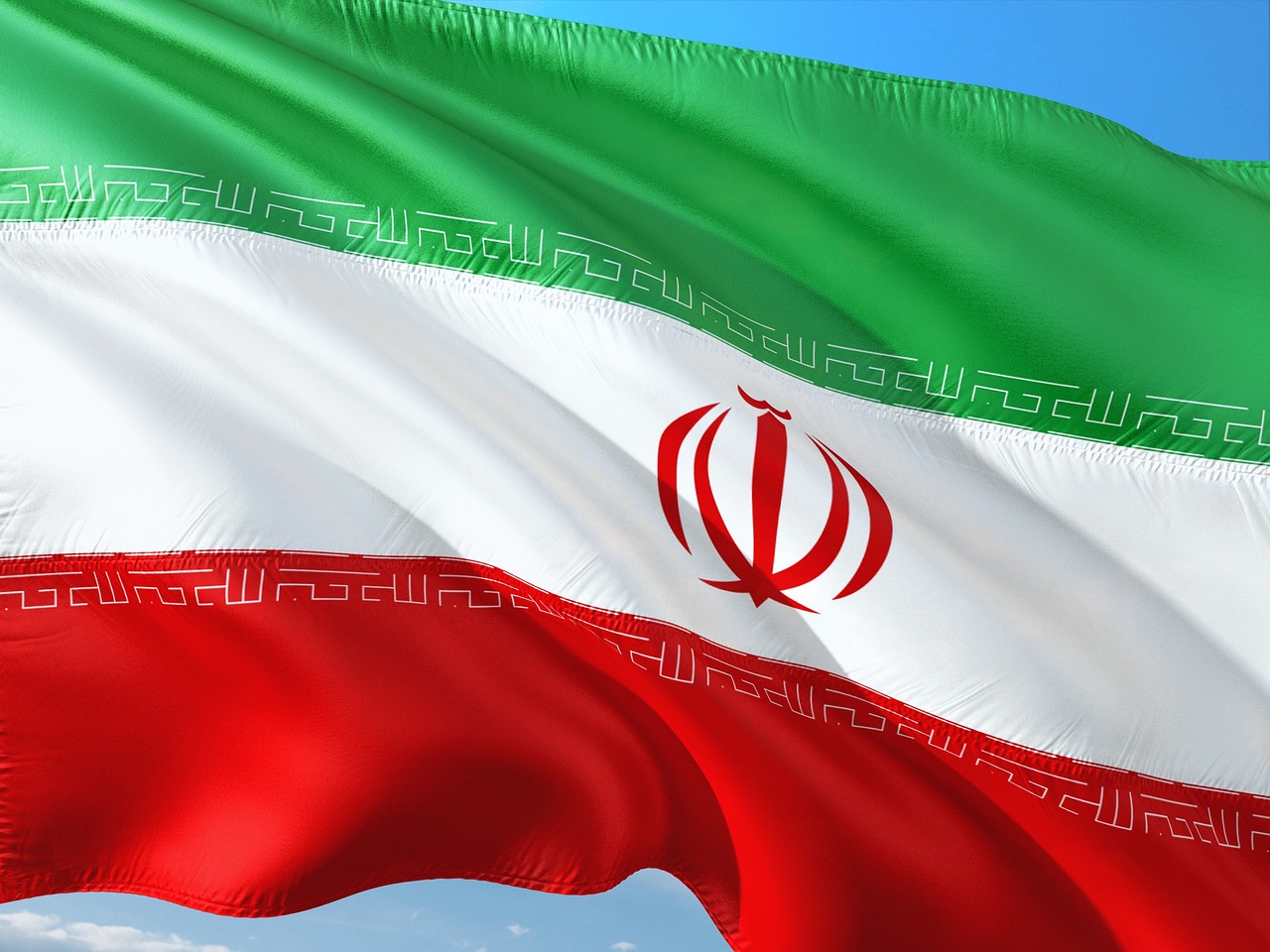 the flag of the country of iraq waving in the wind