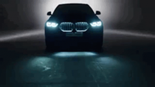 an image of an illuminated car driving under a light