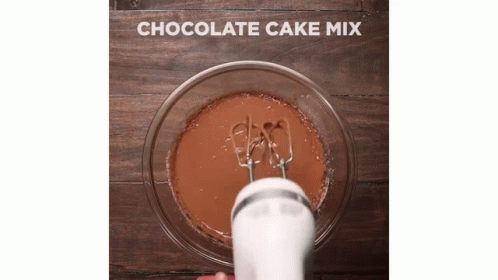 a cake mixing mixer and its handle is holding out the cup