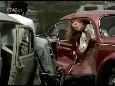 a woman leaning out of a car door and sitting in it