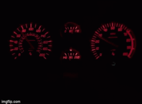 dashboard lights and meters on a vehicle at night