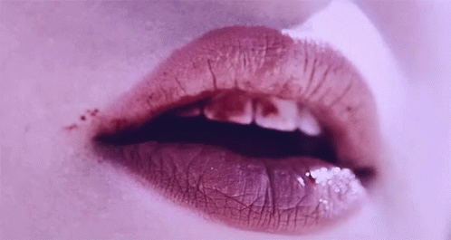 close up view of a woman's lips with blue lipstick