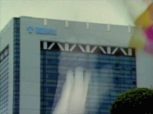 a blurry pograph of a building with a tall sign