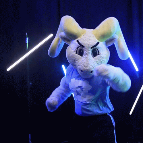 a stuffed bunny on stage with microphones and strings