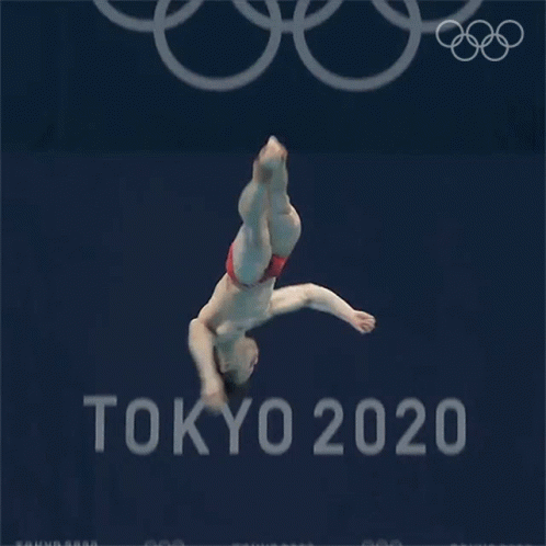 an image of a woman doing a stunt in front of the olympic logo