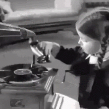 a young child wearing a hat cooking soing in the oven
