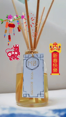 a blue vase with several small toothpicks and paper with animals inside