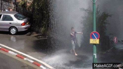 car driving on the road, spraying water over the street