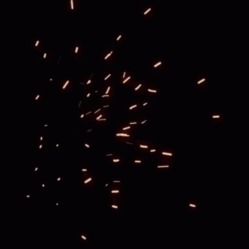 a closeup of a blue sky with lots of fire works